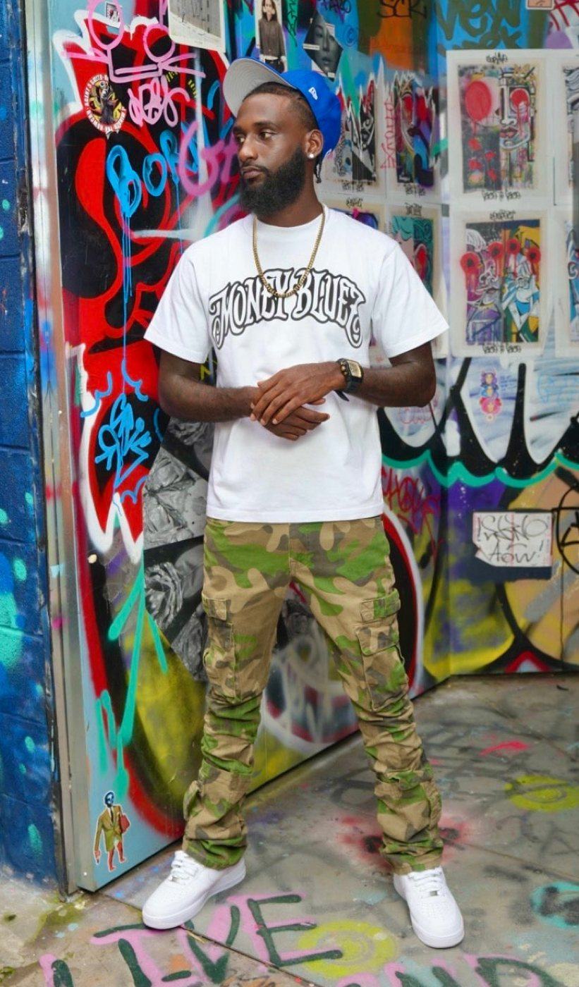 Marlon in the MoneyBluez tee against a graffiti wall